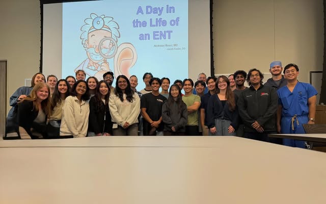 A group gathered after a Day in the Life of an ENT presentation