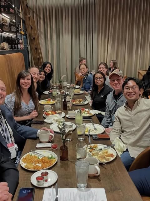 OIG members gathered around a dinner table