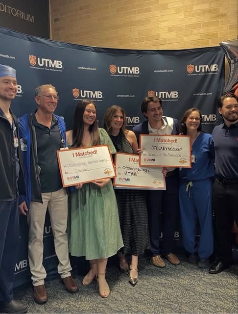 A group at UTMB holding otolaryngology match signs